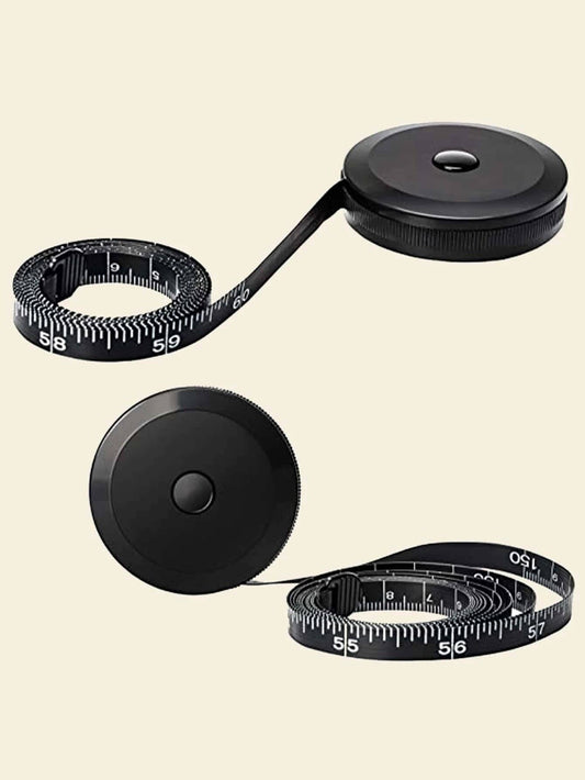 Black retractable measuring tape on a beige background