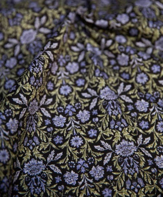 Close-up of floral patterned fabric with blue and green colors.