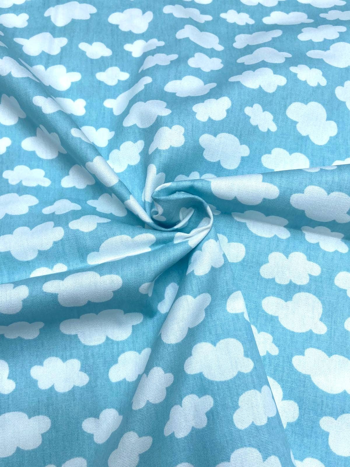 Fabric with white cloud pattern on a blue background