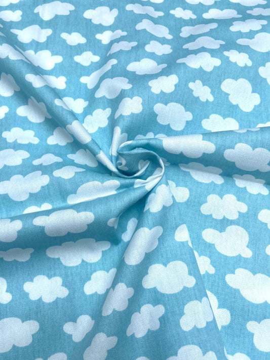 Fabric with white cloud pattern on a blue background