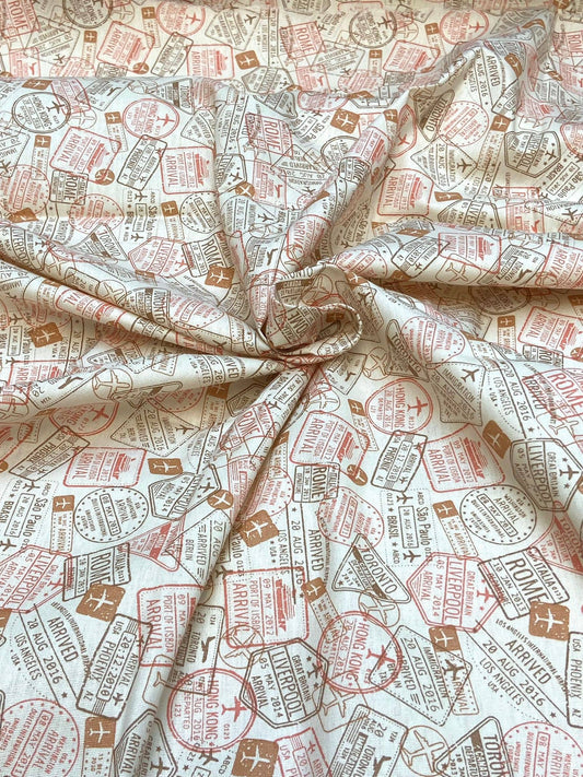 Fabric with travel-themed stamps pattern